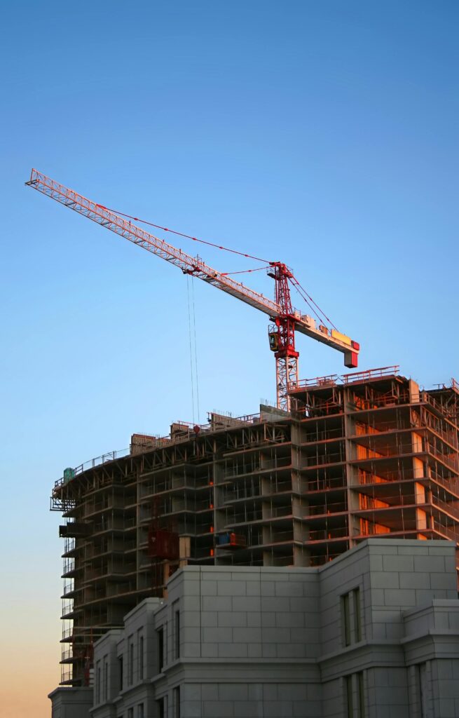 pexels photo 93400 93400 Tower crane on a high-rise building under construction at sunset, showcasing modern urban development.
